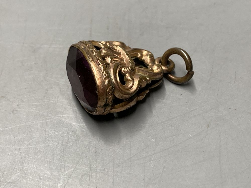 Two gold plated overlaid and gem set fob seals, largest 35mm, a 9ct front and back locket and a scroll brooch.